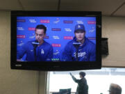 A video screen displays Los Angeles Dodgers' Shohei Ohtani, right, and interpreter Will Ireton during a news conference at Dodger Stadium in Los Angeles, Monday, March 25, 2024. (AP Photo/Jae C.