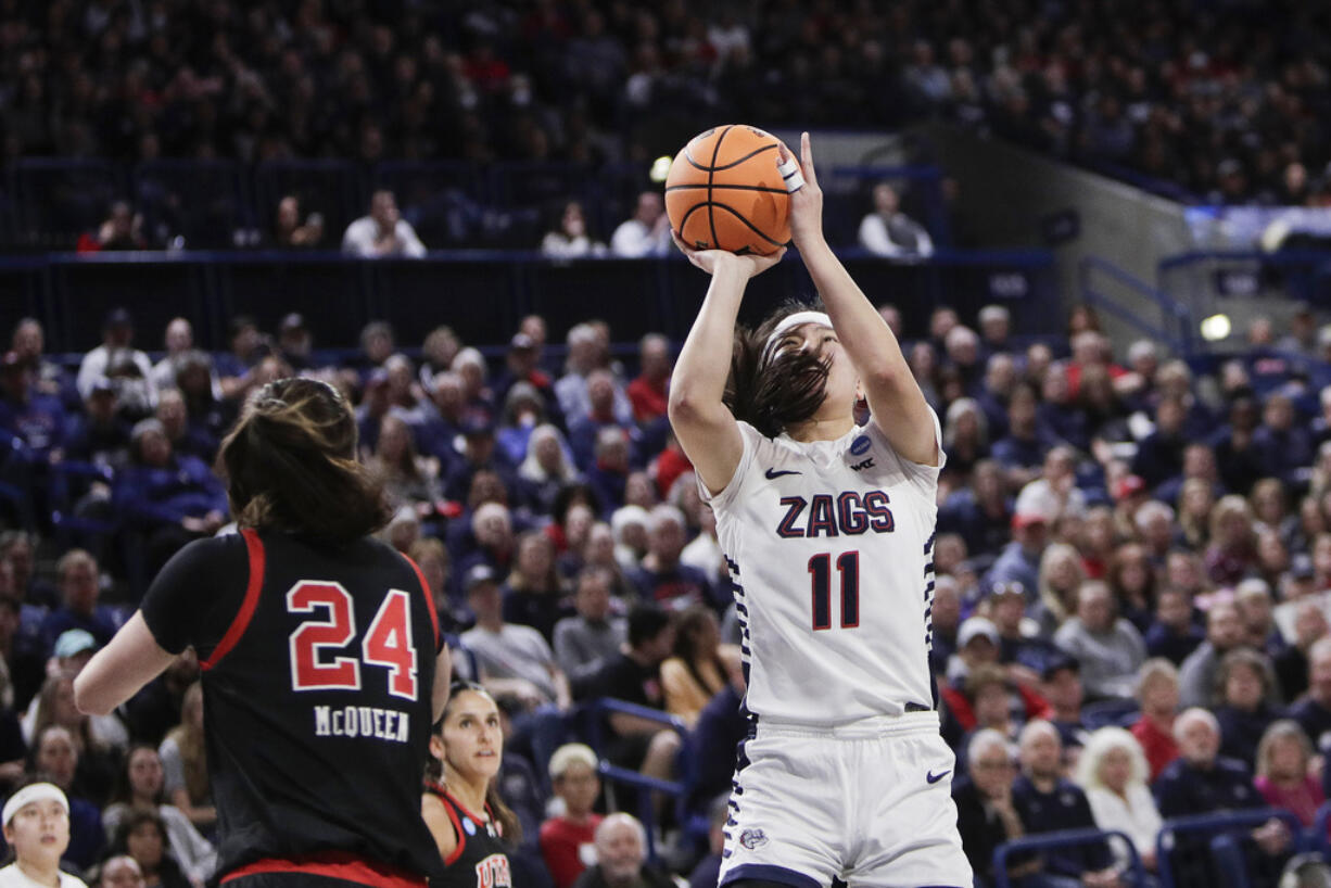 Gonzaga guard Kayleigh Truong (11) shoots next to Utah guard Kennady McQueen (24) during the first half of a second-round college basketball game in the NCAA Tournament in Spokane, Wash., Monday, March 25, 2024.