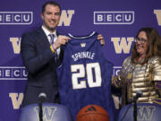 Washington deputy athletic director Erin O'Connell, right, introduces men's basketball coach Danny Sprinkle, Wednesday, March 27, 2024, in Seattle.