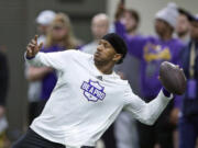 Washington quarterback Michael Penix Jr. throws a pass during the NCAA college's NFL football pro day, Thursday, March 28, 2024, in Seattle.