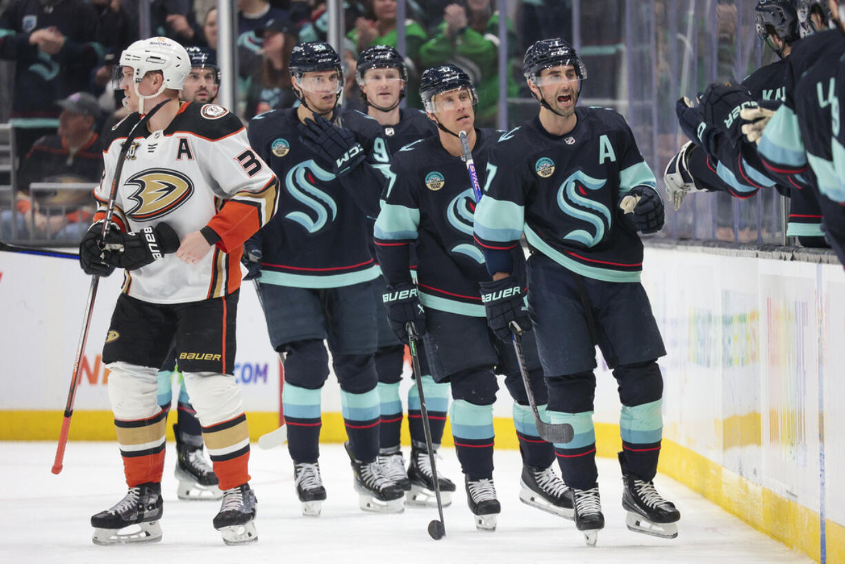 Seattle Kraken right wing Jordan Eberle, right, and center Jaden Schwartz, second from right, head to the bench after Schwartz's goal, as Anaheim Ducks right wing Jakob Silfverberg (33) skates away during the second period of an NHL hockey game Thursday, March 28, 2024, in Seattle.