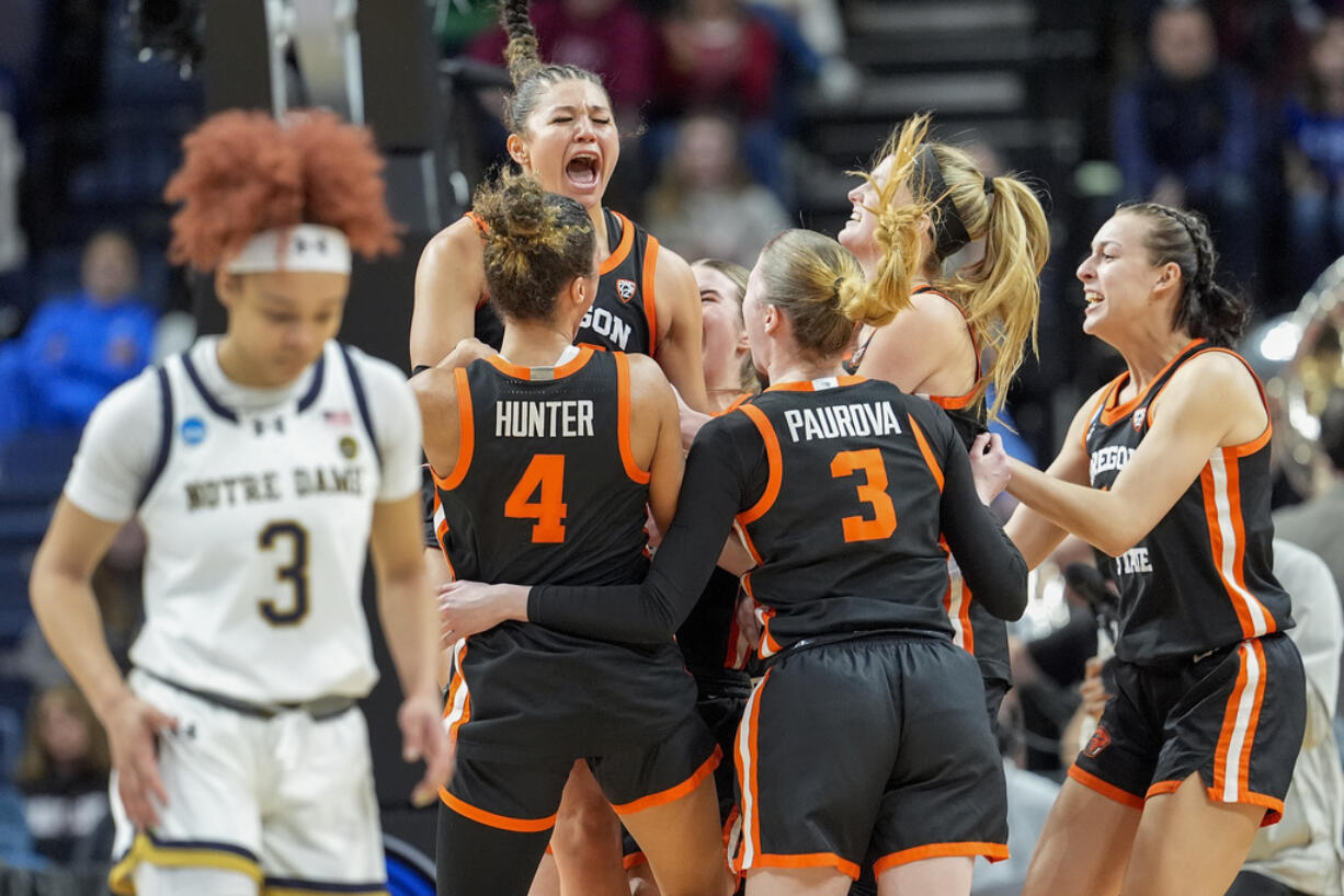 Oregon State players celebrate after defeating Notre Dame in a Sweet Sixteen round college basketball game during the NCAA Tournament, Friday, March 29, 2024, in Albany, N.Y.