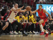 Portland Trail Blazers guard Rayan Rupert (72) steals a pass intended for Miami Heat forward Nikola Jovic (5) during the first half of an NBA basketball game, Friday, March 29, 2024, in Miami.