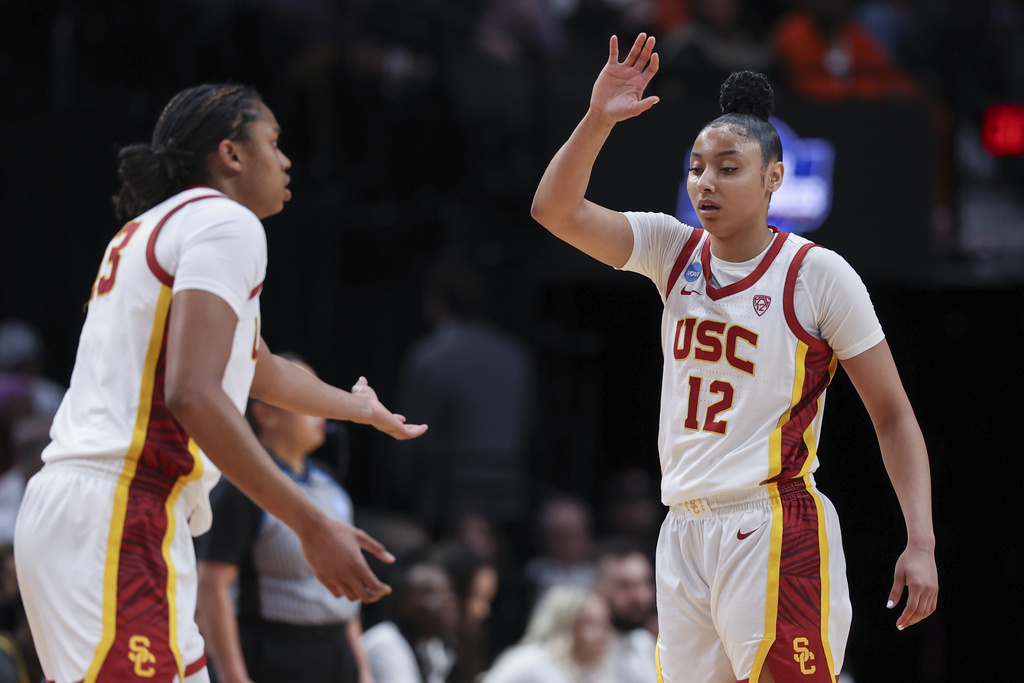 Southern California center Rayah Marshall, left, and guard JuJu Watkins (12) greet each other on the court during the first half of a Sweet 16 college basketball game against Baylor in the women's NCAA Tournament, Saturday, March 30, 2024, in Portland, Ore.