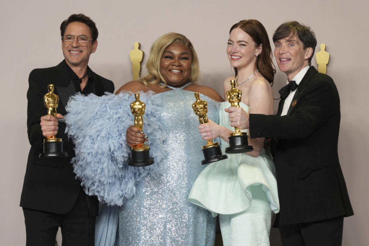 Robert Downey Jr., winner of the award for best performance by an actor in a supporting role for &quot;Oppenheimer,&quot; from left, Da&#039;Vine Joy Randolph, winner of the award for best performance by an actress in a supporting role for &quot;The Holdovers,&quot; Emma Stone, winner of the award for best performance by an actress in a leading role for &quot;Poor Things,&quot; and Cillian Murphy, winner of the award for best performance by an actor in a leading role for &quot;Oppenheimer,&quot; pose in the press room at the Oscars on Sunday, March 10, 2024, at the Dolby Theatre in Los Angeles.