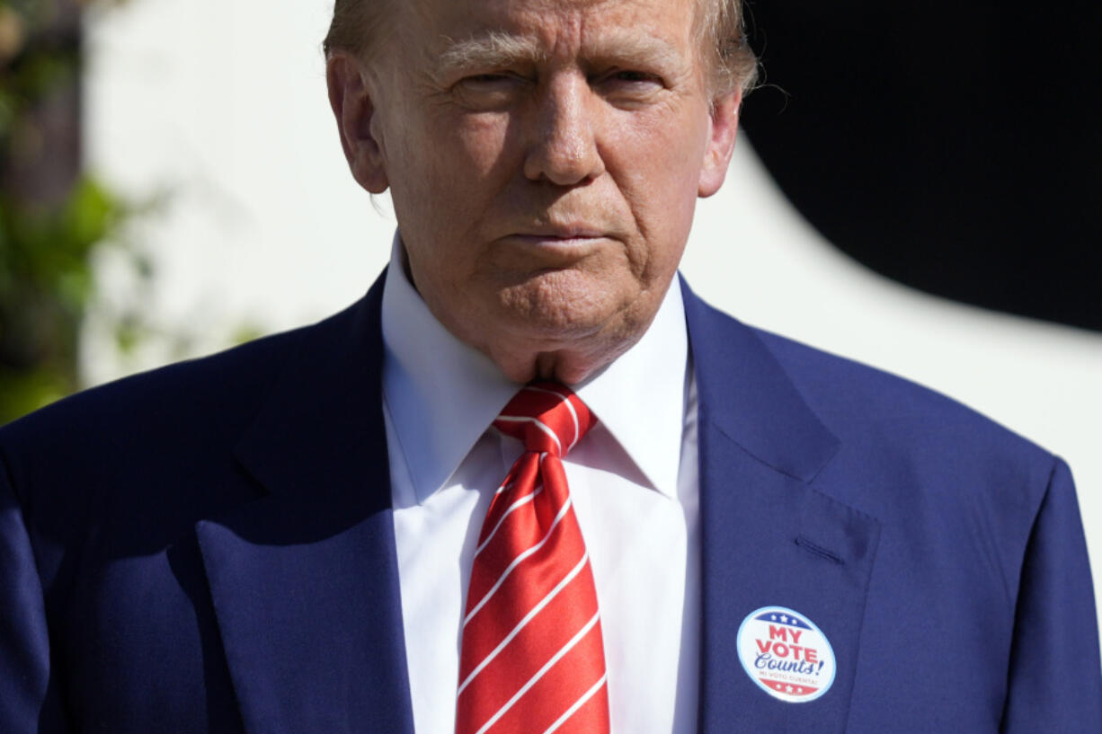 Republican presidential candidate former President Donald Trump listens to a question from a reporter after voting in the Florida primary election in Palm Beach, Fla., Tuesday, March 19, 2024.