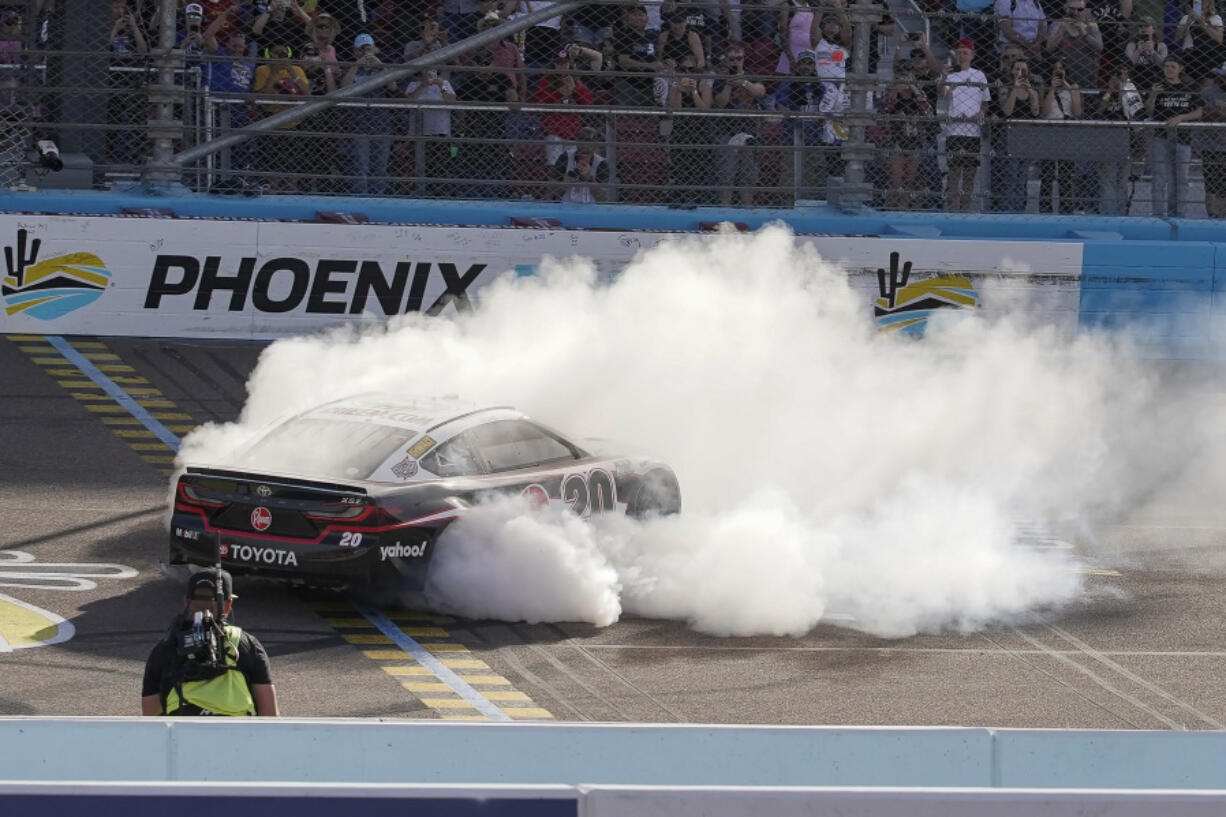 Christopher Bell does a burnout after a NASCAR Cup Series win Sunday in Avondale, Ariz.