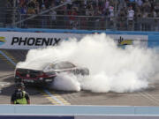 Christopher Bell does a burnout after a NASCAR Cup Series win Sunday in Avondale, Ariz.
