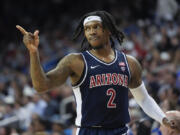 Arizona guard Caleb Love (2) points to a teammate during the first half of an NCAA college basketball game against UCLA in Los Angeles, Thursday, March 7, 2024. (AP Photo/Jae C.