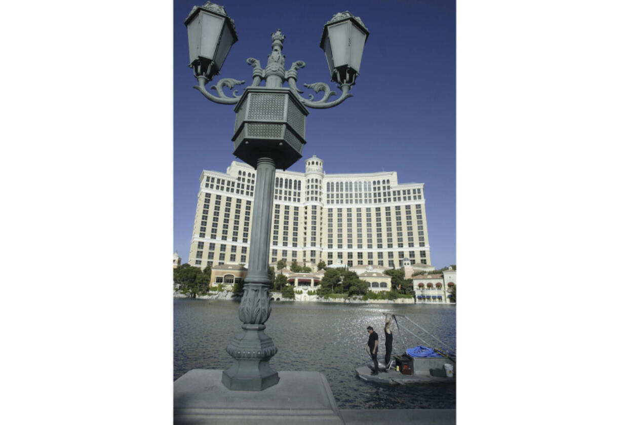 FILE - A crew cleans and tests the fountains at the Bellagio Casino and Hotel resort in Las Vegas, Nevada, on April 14, 2004.