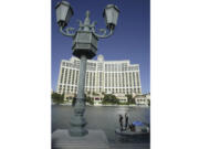 FILE - A crew cleans and tests the fountains at the Bellagio Casino and Hotel resort in Las Vegas, Nevada, on April 14, 2004.