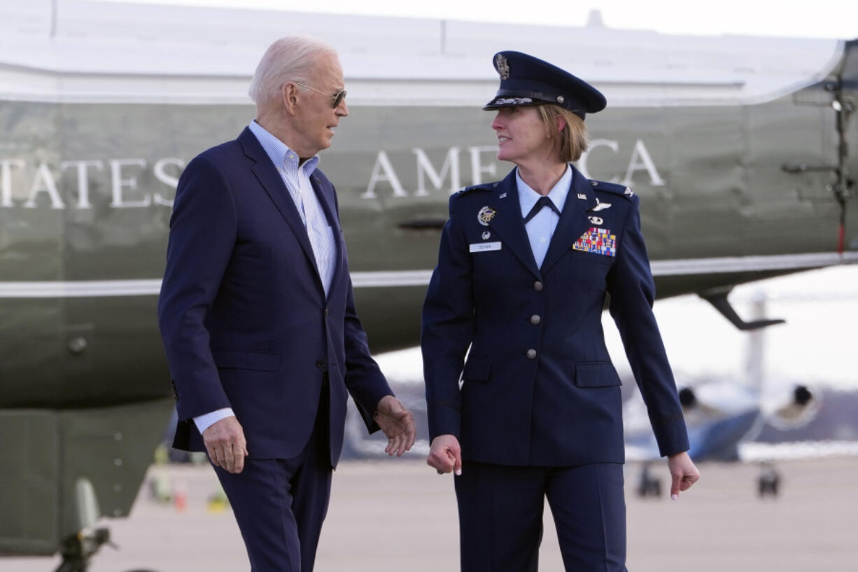 President Joe Biden, escorted by Col. Angela Ochoa, commander of the 89th Airlift Wing, arrives to board Air Force One at Andrews Air Force Base, Md., Tuesday March 19, 2024, en route to Nevada.