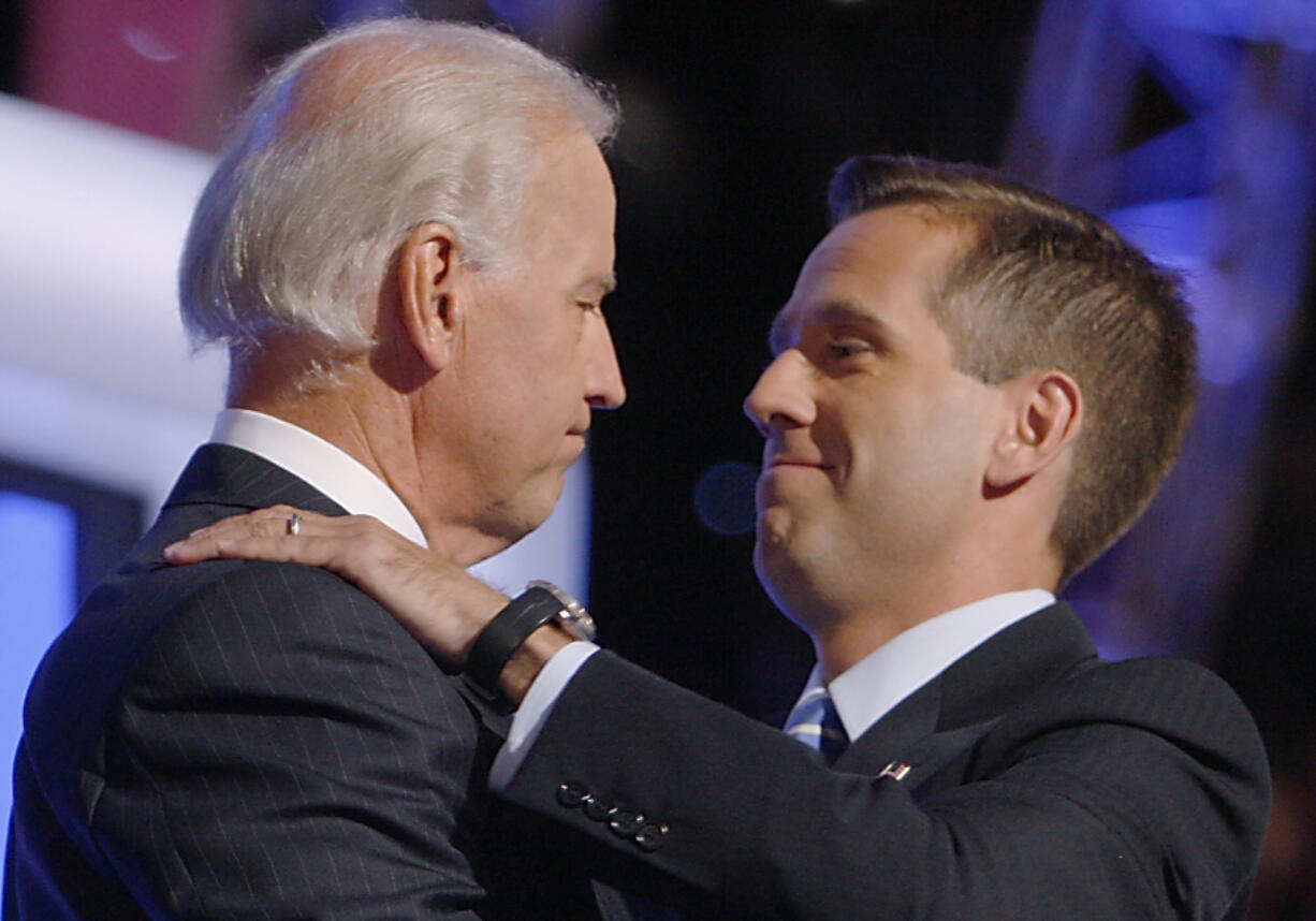 FILE - Then-Democratic vice presidential candidate Sen. Joe Biden, D-Del., left, embraces his son Beau Biden on stage at the Democratic National Convention in Denver, Aug. 27, 2008.