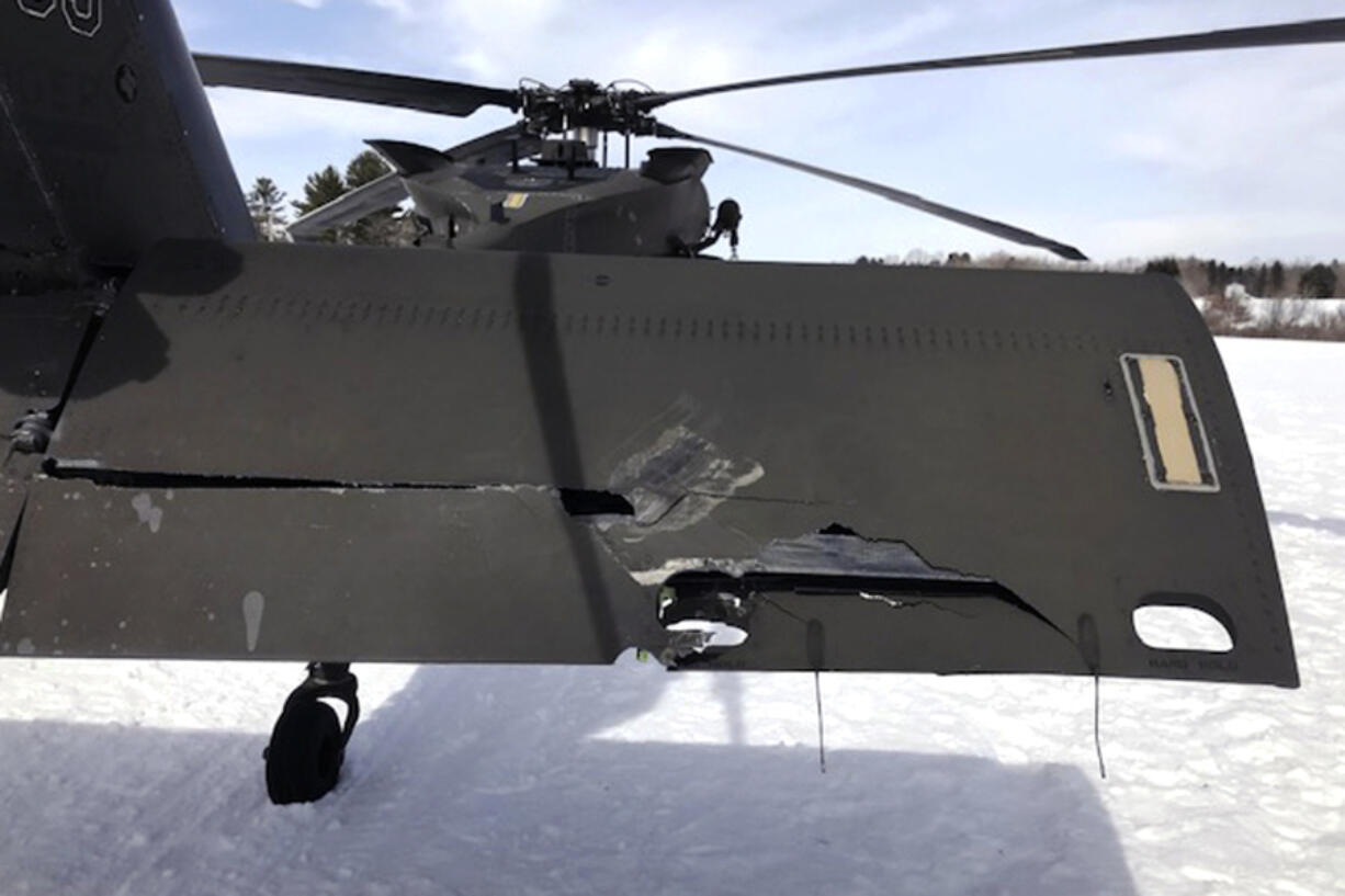 In this U.S. Army photograph by attorney Douglas Desjardins, a damaged Black Hawk helicopter rests on the snow, March 13, 2019, in Worthington, Mass. A Massachusetts man wants the government to pay nearly $10 million after being badly injured in a crash with a Black Hawk helicopter. The lawsuit filed by Jeffrey Smith against the government follows a 2019 crash in which Smith&rsquo;s snowmobile collided with the helicopter that was parked on a trail at dusk. (U.S.