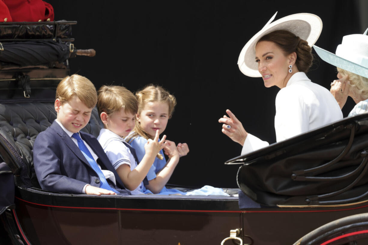 FILE - From left, Britain&#039;s Prince George, Prince Louis, Princess Charlotte, Kate, Duchess of Cambridge and Camilla, Duchess of Cornwall ride in a carriage during the Trooping the Color parade in London, Thursday June 2, 2022, on the first of four days of celebrations to mark the Platinum Jubilee.