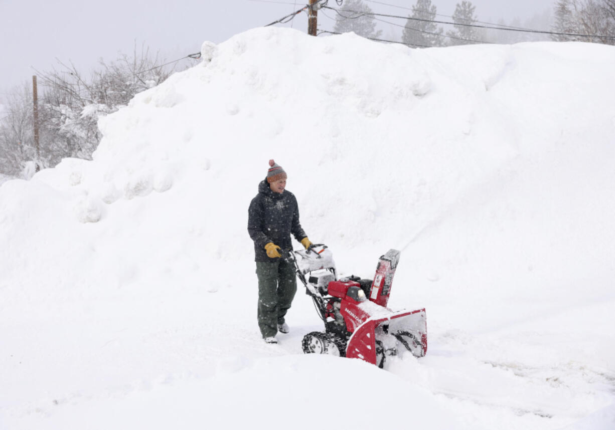 J.J. Morgan clears snow near the historic Truckee Hotel in downtown Truckee, Calif., on Sunday, March 3, 2024.