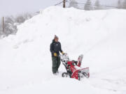 J.J. Morgan clears snow near the historic Truckee Hotel in downtown Truckee, Calif., on Sunday, March 3, 2024.