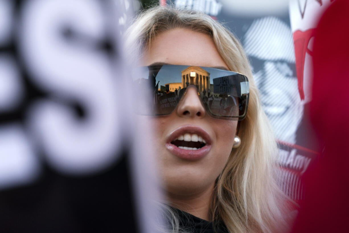 FILE - Isabella DeLuca, of Long Island, N.Y., appears outside the Supreme Court, Oct. 26, 2020, on Capitol Hill in Washington. DeLuca, a conservative social media influencer, has been charged with storming the U.S. Capitol. Court records unsealed Monday, March 18, 2024, show that DeLuca is charged with misdemeanors, including theft of government property, disorderly conduct and entering a restricted area. She was arrested last Friday in Irvine, Calif.
