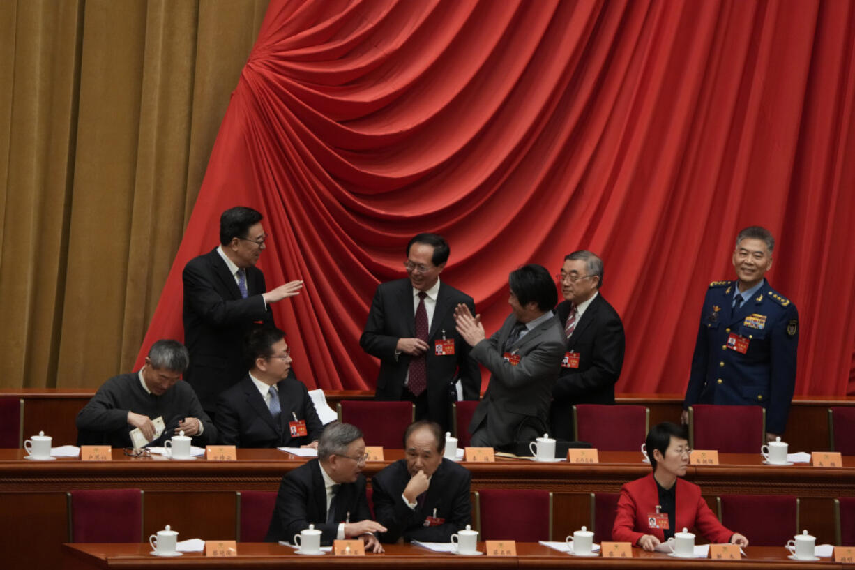 Delegates greet each other as they arrive for the opening session of the Chinese People&rsquo;s Political Consultative Conference held the Great Hall of the People in Beijing, Monday, March 4, 2024.
