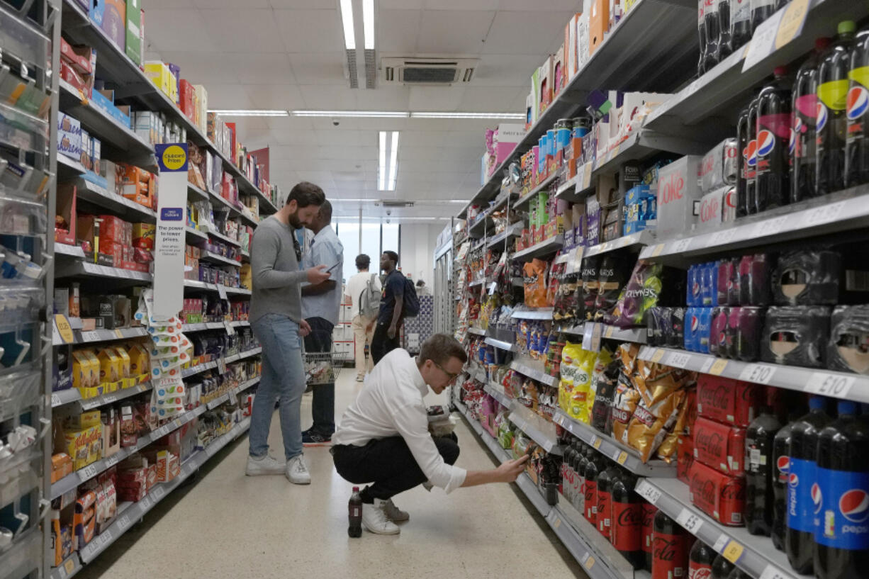FILE - Shoppers buy food in a supermarket in London, on Aug. 17, 2022. Food prices and overall inflation will rise as temperatures climb with climate change, a new study by an environmental scientist and the European Central Bank found.