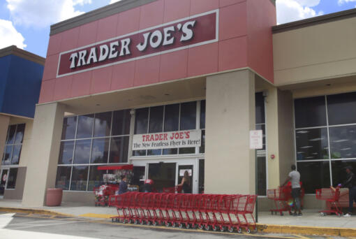 FILE - People stand in line waiting to enter Trader Joe&rsquo;s to buy groceries in Pembroke Pines, Fla., on March 24, 2020. Don&rsquo;t count on a favorite store being open on Easter Sunday. Several stores will be closed March 31, 2024, in observance of the holiday.
