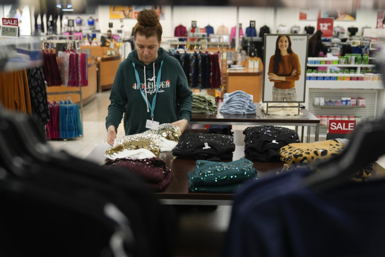 FILE - An employee straightens displays at a Kohl&rsquo;s store in Clifton, N.J., Jan. 26, 2024. On Friday, March 8, 2024, the U.S. government issues its February jobs report.