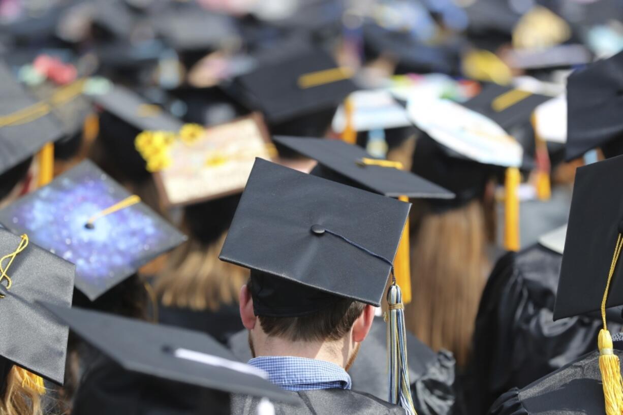 FILE - Graduates at the University of Toledo commencement ceremony in Toledo, Ohio, May 5, 2018.  Another 78,000 Americans are getting their federal student loans canceled through a program that helps teachers, nurses, firefighters and other public servants, the Biden administration announced Thursday.  The Education Department is canceling the borrowers&rsquo; loans because they reached 10 years of payments while working in public service, making them eligible for relief under the Public Service Loan Forgiveness program.