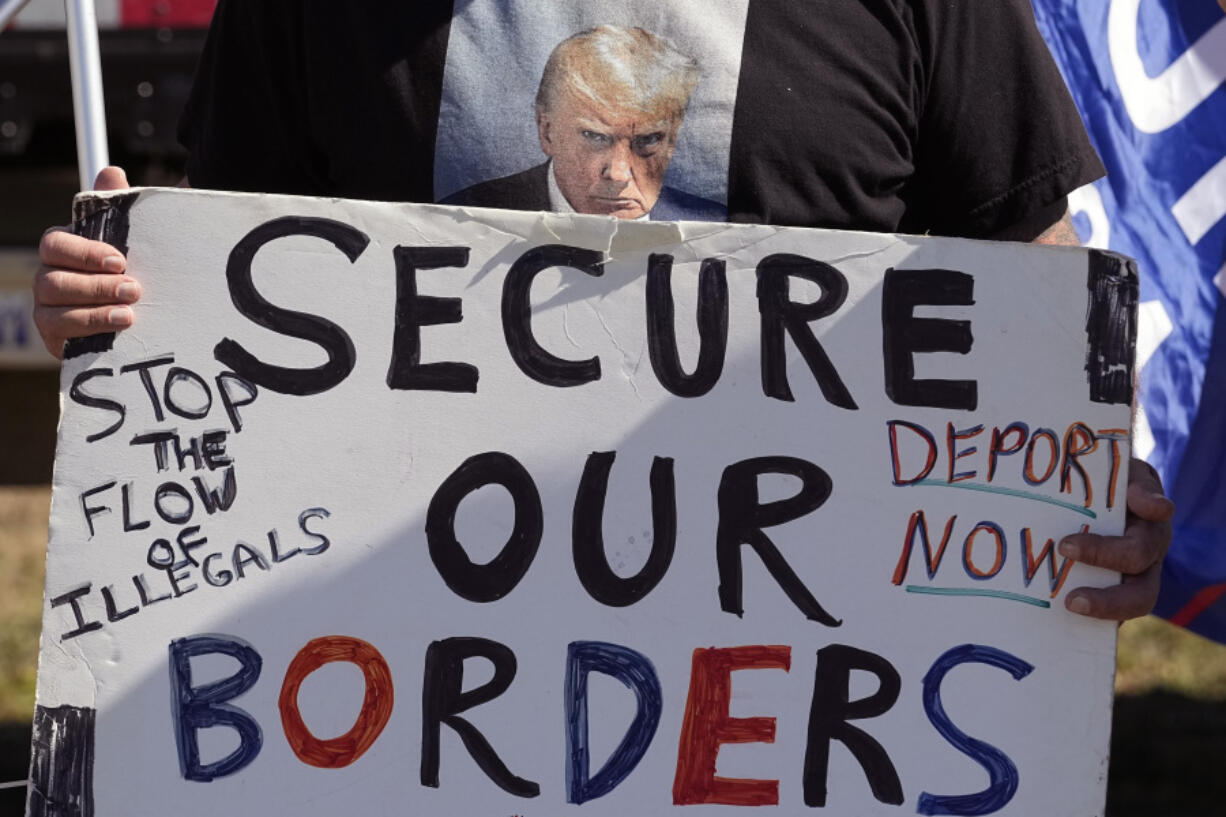 FILE - Phill Cady holds a sign during a &ldquo;Take Our Border Back&rdquo; rally on Feb. 3, 2024, in Quemado, Texas. Online actors tied to the Kremlin have begun pushing misleading and incendiary claims about U.S. immigration in an apparent bid to target American voters ahead of the 2024 election.