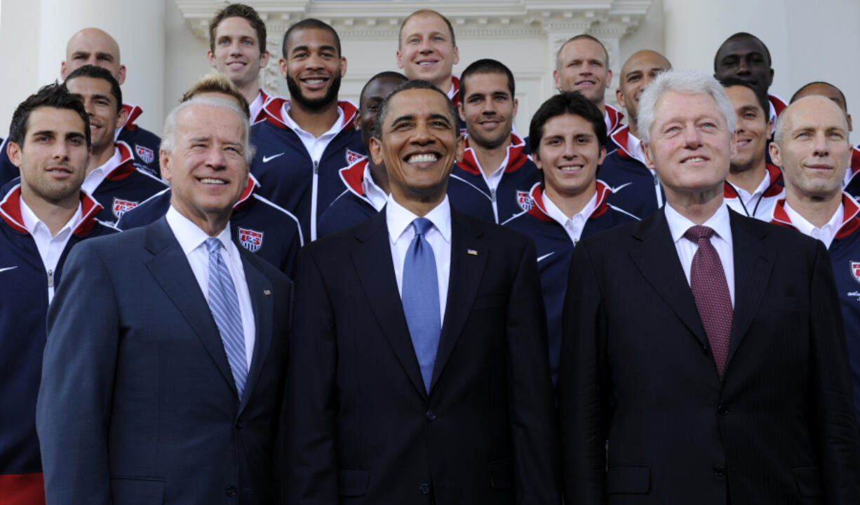 FILE - President Barack Obama, flanked by Vice President Joe Biden, left, and former President Bill Clinton, right, pose for a photo with the U.S. World Cup soccer team under the North Portico of the White House in Washington, May 27, 2010. President Joe Biden will share a stage with Barack Obama and Bill Clinton on Thursday in New York as he raises money for his reelection campaign. It&rsquo;s a one-of-a-kind political extravaganza that will showcase decades of Democratic leadership.