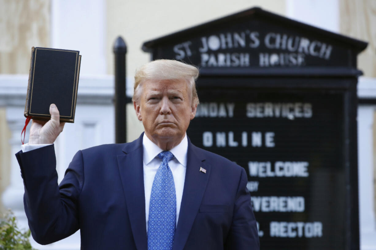 FILE - President Donald Trump holds a Bible as he visits outside St. John&#039;s Church across Lafayette Park from the White House, June 1, 2020, in Washington.  Trump is now selling Bibles as he runs to return to the White House.