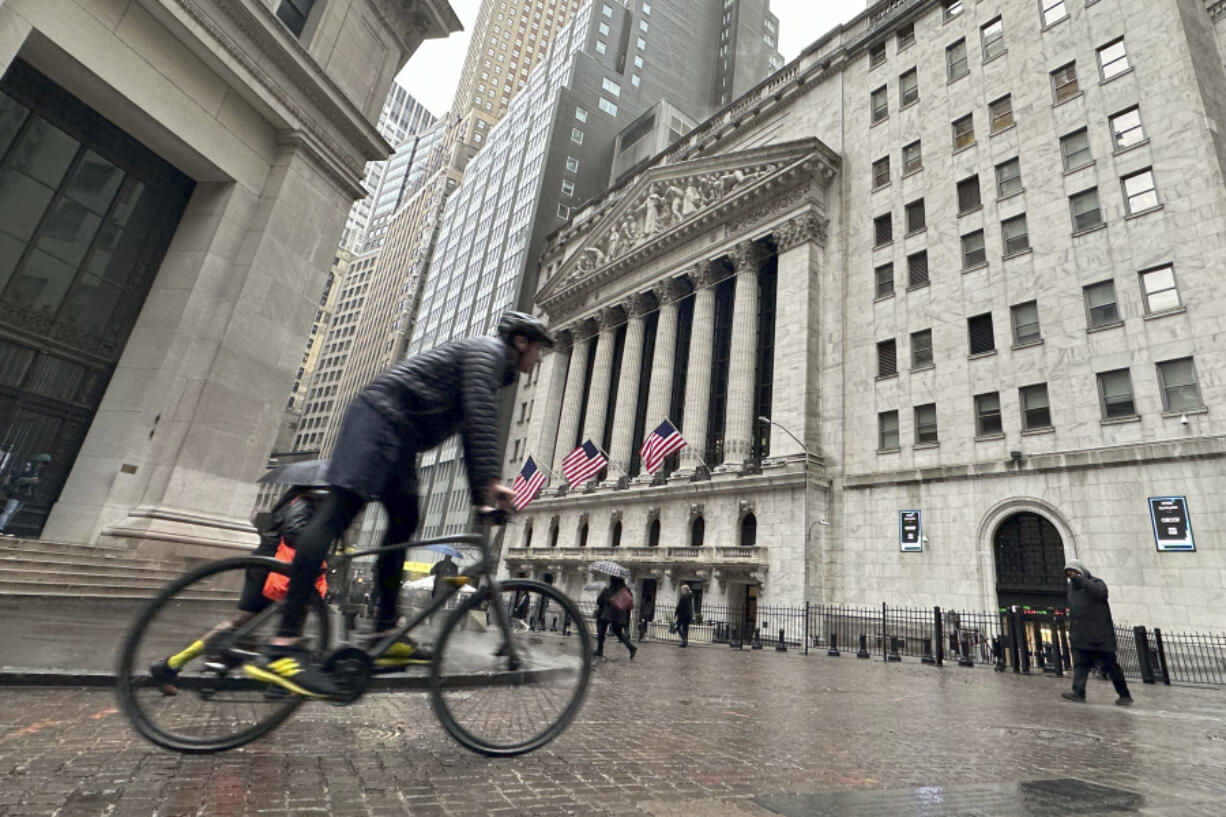A bicyclist passes the New York Stock Exchange on Tuesday, March 5, 2024, in New York. Wall Street pointed modestly lower as more retailers post results from the holiday season and ahead of appearance by Federal Reserve Chair Jerome Powell before Congress later this week.