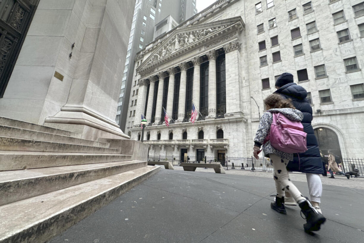 People pass the New York Stock Exchange on Wednesday, March 6, 2024, in New York. World shares are mostly higher after tumbling Big Tech stocks dragged Wall Street to its worst day in three weeks.