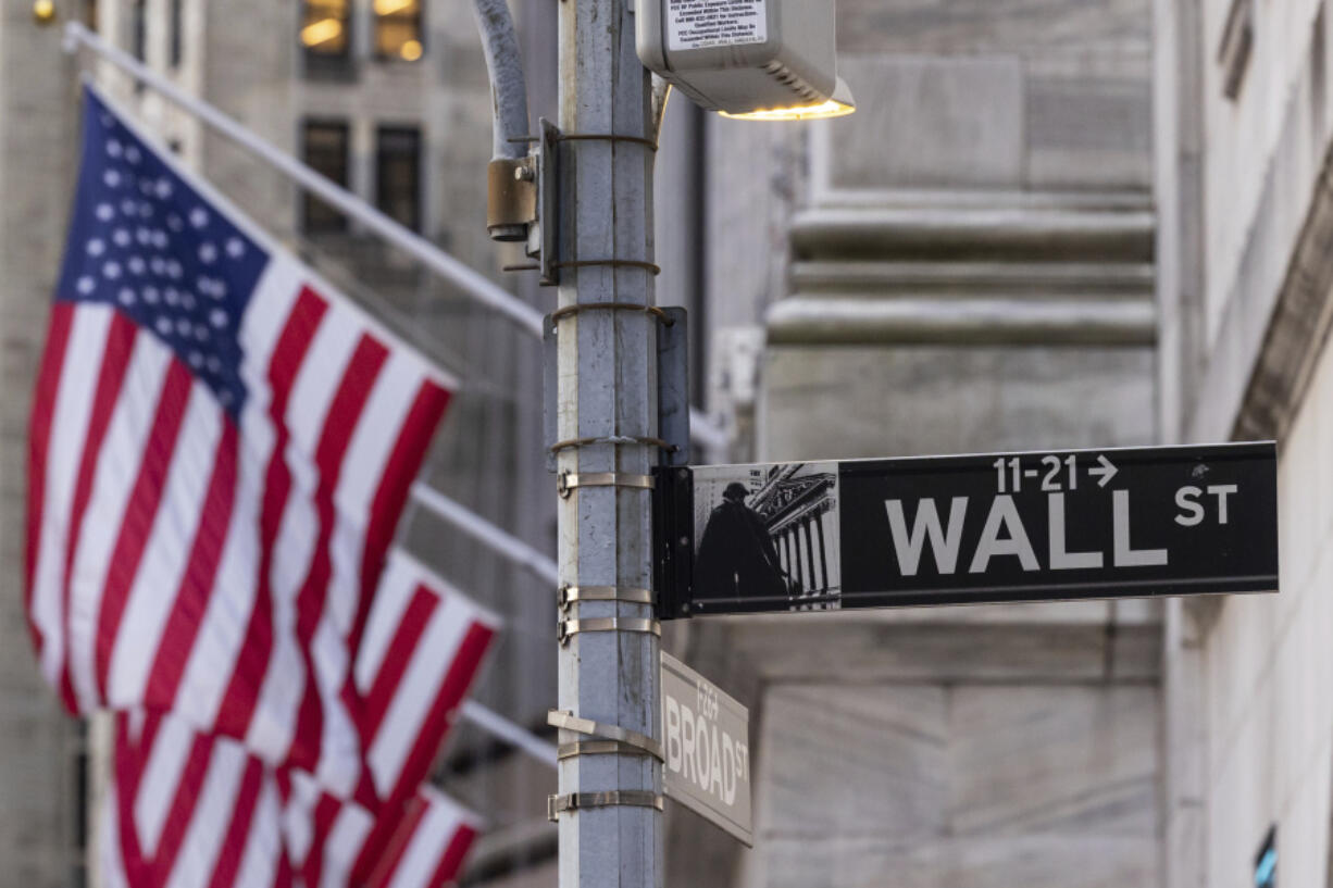 Wall Street sign is seen outside the New York Stock Exchange,  Thursday, March. 21, 2024.   Reddit shares will begin trading Thursday.