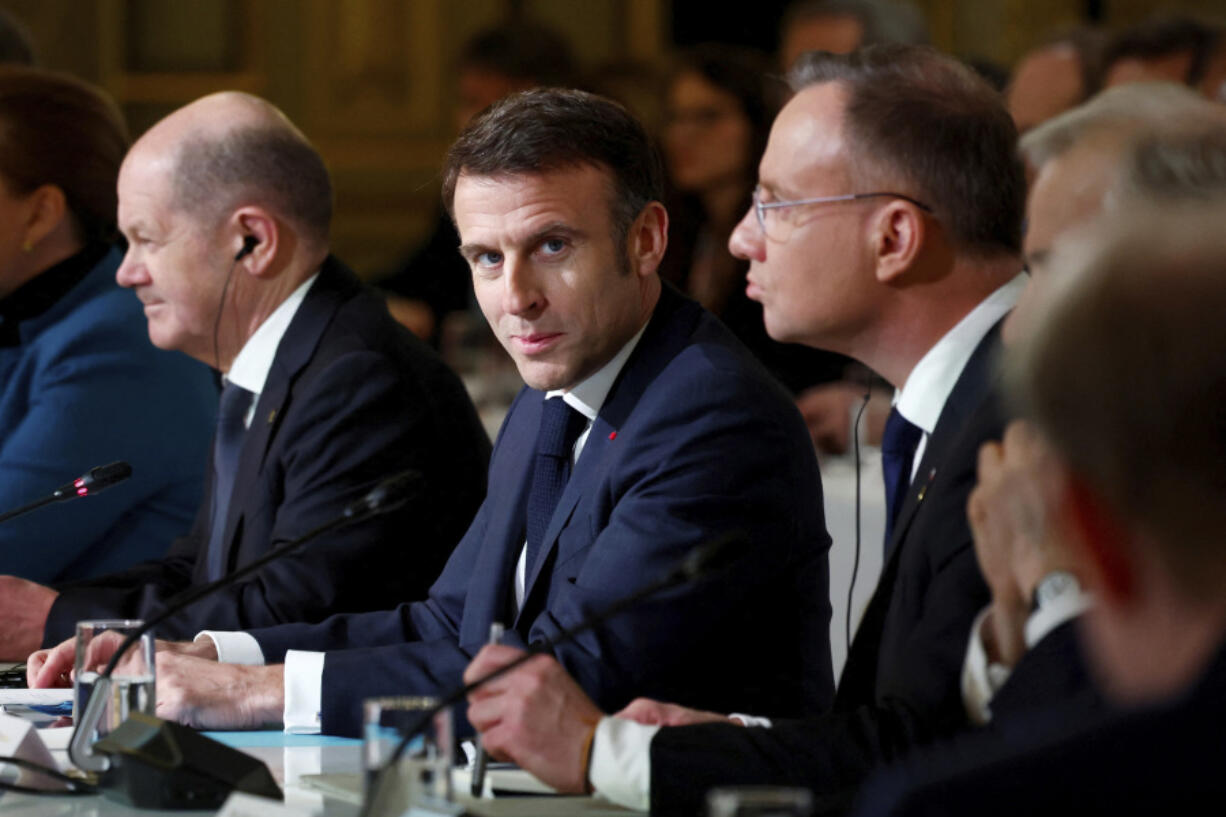French President Emmanuel Macron, center, delivers a speech at the Elysee Palace in Paris, Monday, Feb. 26, 2024. More than 20 European heads of state and government and other Western officials are gathering in a show of unity for Ukraine, signaling to Russia that their support for Kyiv isn&rsquo;t wavering as the full-scale invasion grinds into a third year.