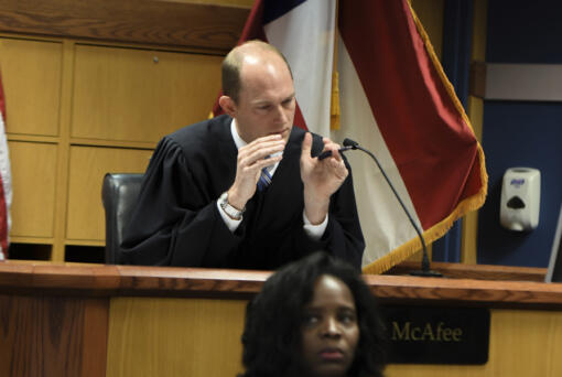 Judge Scott McAfee addresses the lawyers during a hearing on charges against former President Donald Trump in the Georgia election interference case on Thursday, March 28, 2024 in Atlanta.  Lawyers for Trump argued in a court filing that the charges against him in the Georgia election interference case seek to criminalize political speech and advocacy conduct that is protected by the First Amendment.