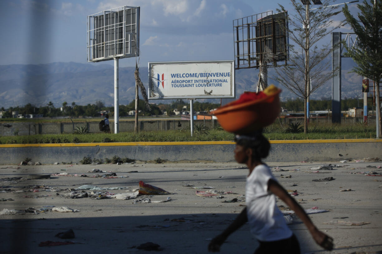 A pedestrian walks past the international airport in Port-au-Prince, Haiti, Monday, March 4, 2024. Gang members exchanged gunfire with police and soldiers around the airport in the latest of a series of attacks on government sites, which includes a mass escape from the country&rsquo;s two biggest prisons.