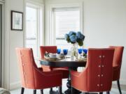 &ldquo;The orange dining chairs in this airy waterfront dining room are from Kravet,&rdquo; says Designer Jillian Hayward Schaible of Susan Hayward interiors. She says you can spend less on small furnishings and accessories, but it&rsquo;s worth investing in the pieces that you sit, sleep and eat on.