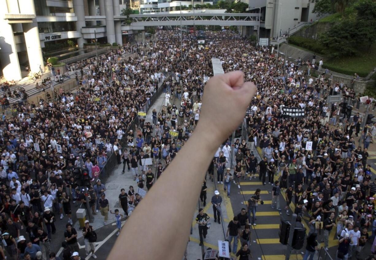 FILE - Tens of thousands of people march through a Hong Kong street Tuesday, July 1, 2003, to protest the Hong Kong government&rsquo;s plans to enact an anti-subversion bill that critics feared would curtail civil liberties. The bill was withdrawn after the march.