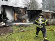 Vancouver Fire Department firefighters battle a house fire in east Vancouver on Sunday morning.