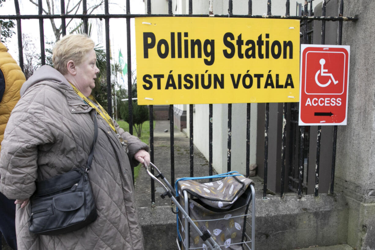 A woman arrives to vote in a referendum on the proposed changes to the wording of the Constitution relating to the areas of family and care are seen at Treasa Naofa on Donore Avenue, Dublin , in Dublin, Ireland, Friday, March 8, 2024. As the world marks International Women&rsquo;s Day, in Ireland, voters are deciding on Friday whether to change the constitution to remove passages referring to women&rsquo;s domestic duties and broadening the definition of the family.