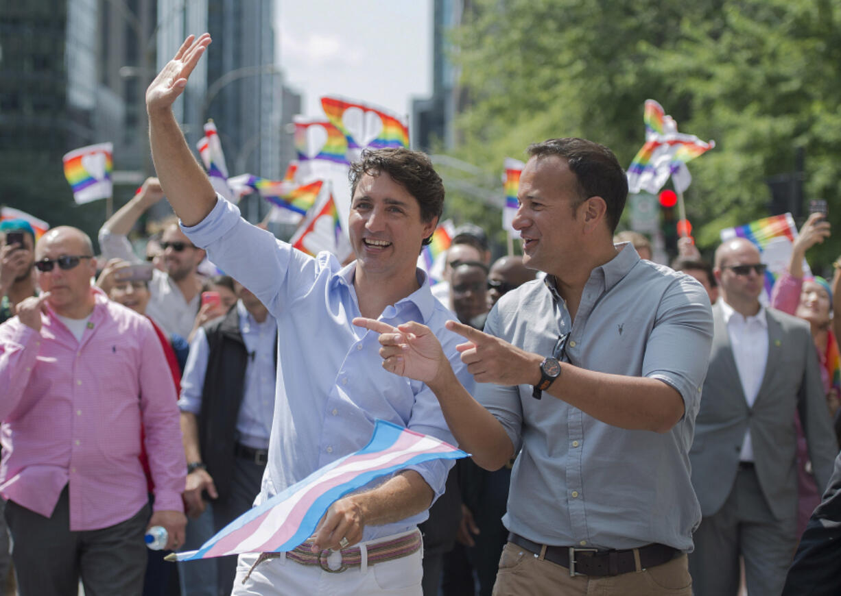 FILE - Prime Minister Justin Trudeau, left, talks with Irish Prime Minister Leo Varadkar, right, during the annual pride parade in Montreal, Sunday, Aug. 20, 2017. Irish Prime Minister Leo Varadkar says he will step down as leader of the country as soon as a successor is chosen. Varadkar announced Wednesday he is quitting immediately as head of the center-right Fine Gael party, part of Ireland&rsquo;s coalition government.