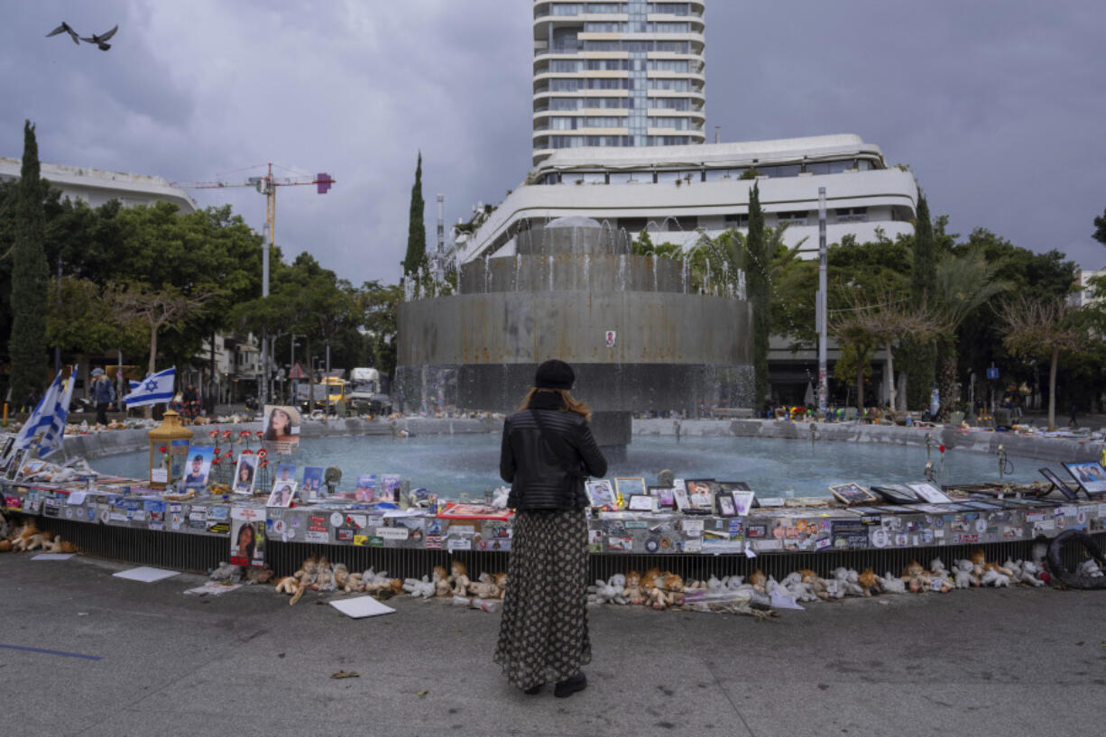 A woman prays at a vigil for the victims and hostages from the bloody Oct. 7 cross-border attack by Hamas militants, in Tel Aviv, Israel, Tuesday, March 19, 2024. Approximately 100 hostages are still alive in Gaza, according to Israeli government sources.