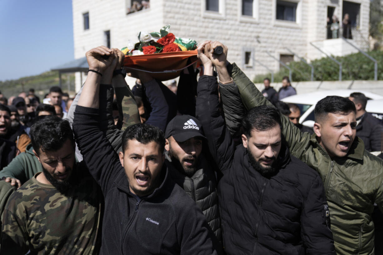 Mourners carry the body of Amr al-Najjar, 11, draped in the Hamas flag, during his funeral in the West Bank village of Burin, near Nablus, Tuesday, March 5, 2024. Palestinian media reports that he was shot during an Israeli military incursion into the village of Burin. The Israeli military says they opened fire in the village and are aware of reports of a minor being killed. According to the Palestinian Red Crescent emergency service, the child suffered a gunshot to the head before dying of his wounds.
