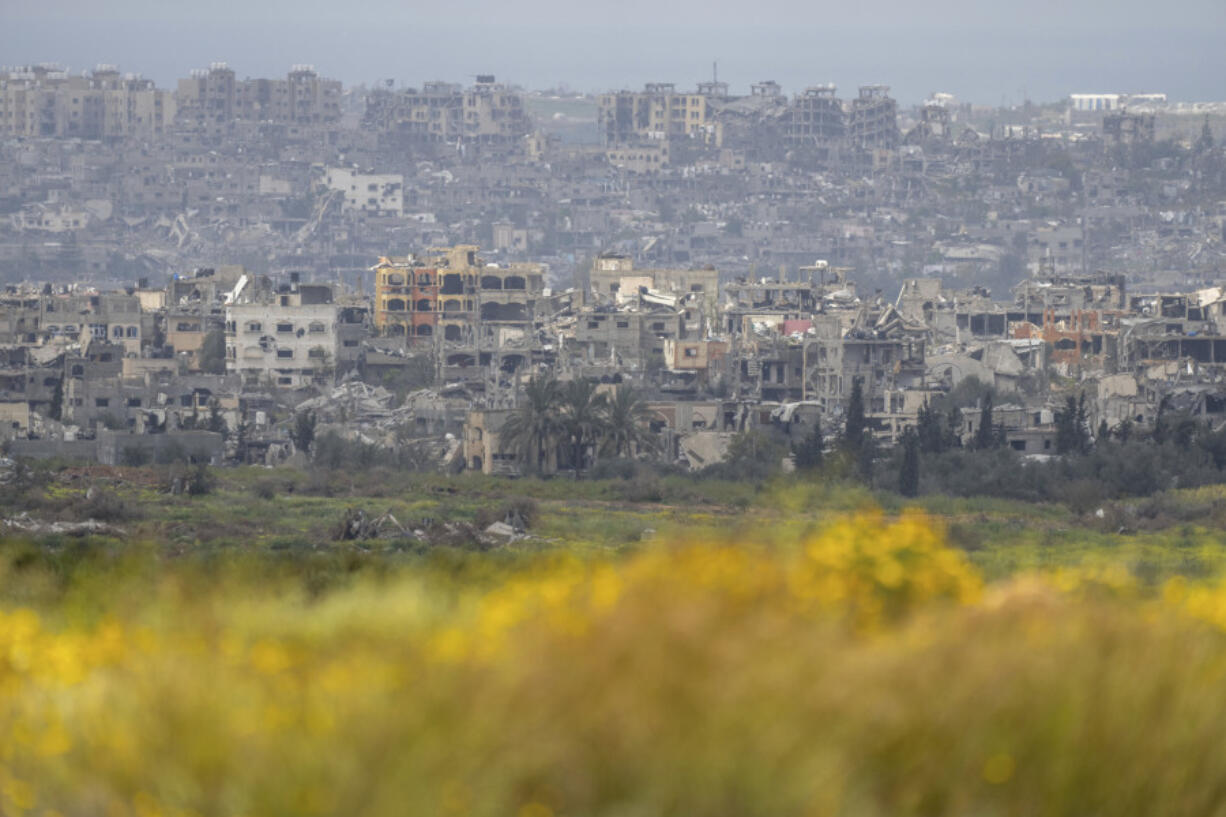 Destroyed buildings stand in the Gaza Strip as seen from southern Israel, Monday.