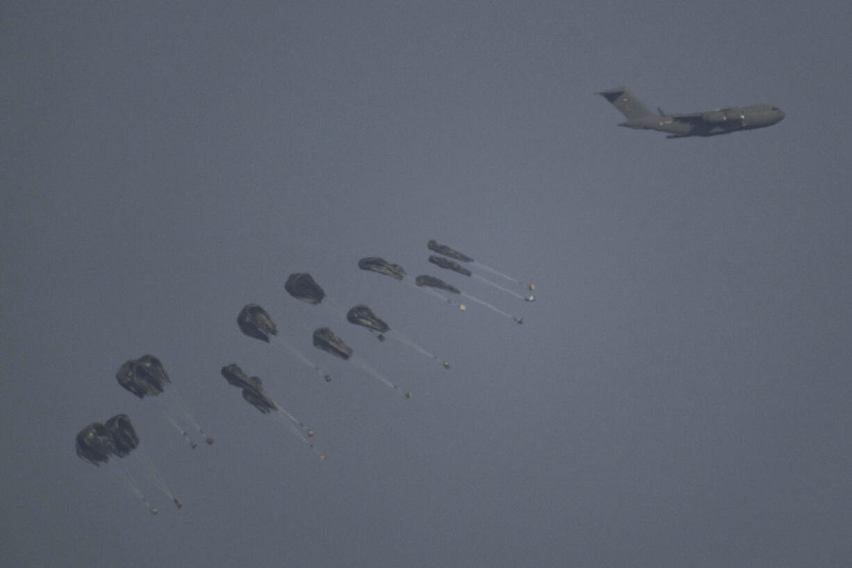 An aircraft airdrops humanitarian aid over northern Gaza Strip as seen from southern Israel, Thursday, March 28, 2024.