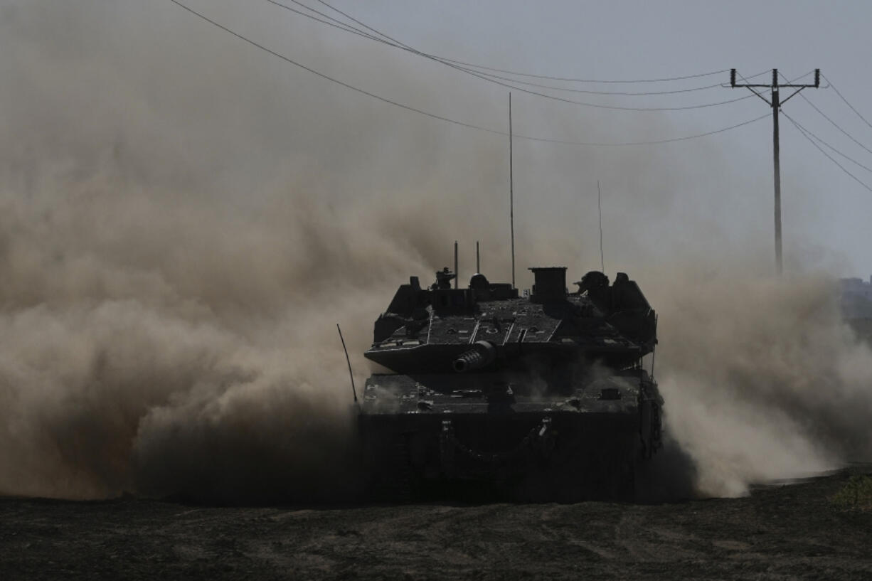 An Israeli tank moves near the Gaza Strip border in southern Israel, Wednesday, March 13, 2024.