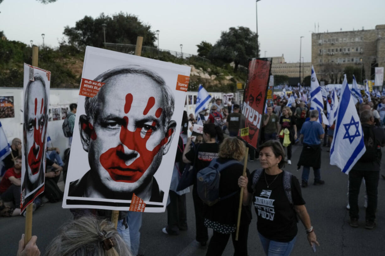 People take part in a protest against Israeli Prime Minister Benjamin Netanyahu&#039;s government and call for the release of hostages held in the Gaza Strip by the Hamas militant group outside of the Knesset, Israel&#039;s parliament, in Jerusalem, Sunday, March 31, 2024.