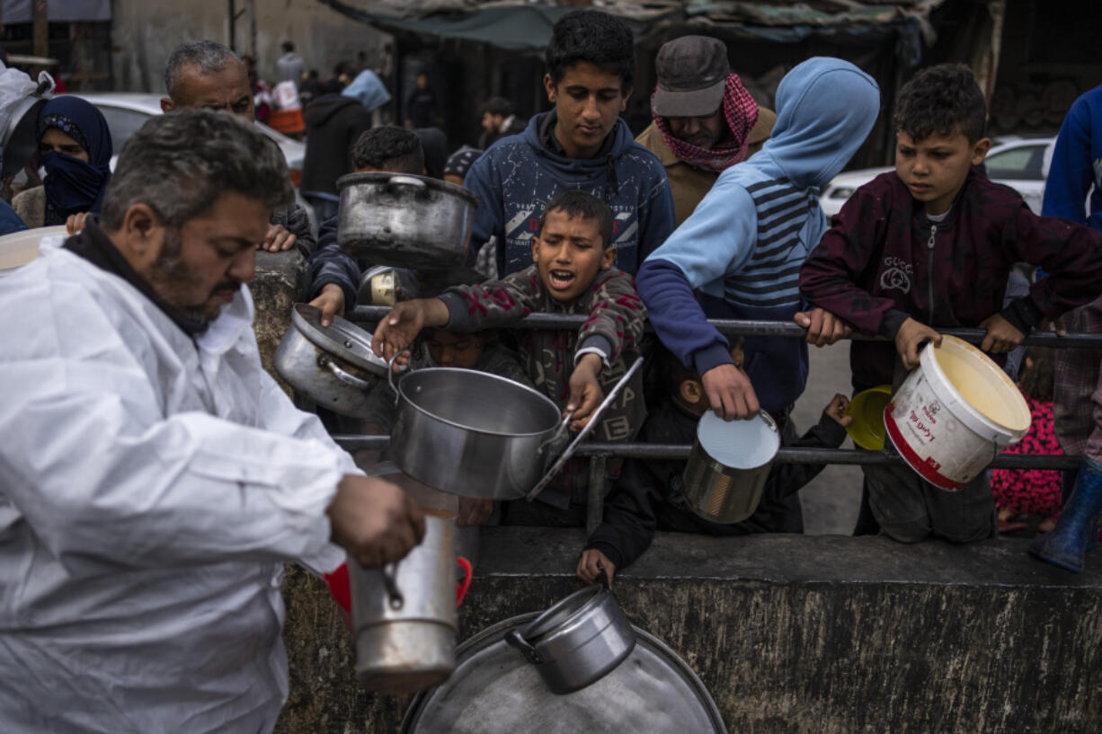Palestinians line up for free food in Rafah, Gaza Strip, Friday, Feb. 23, 2024.