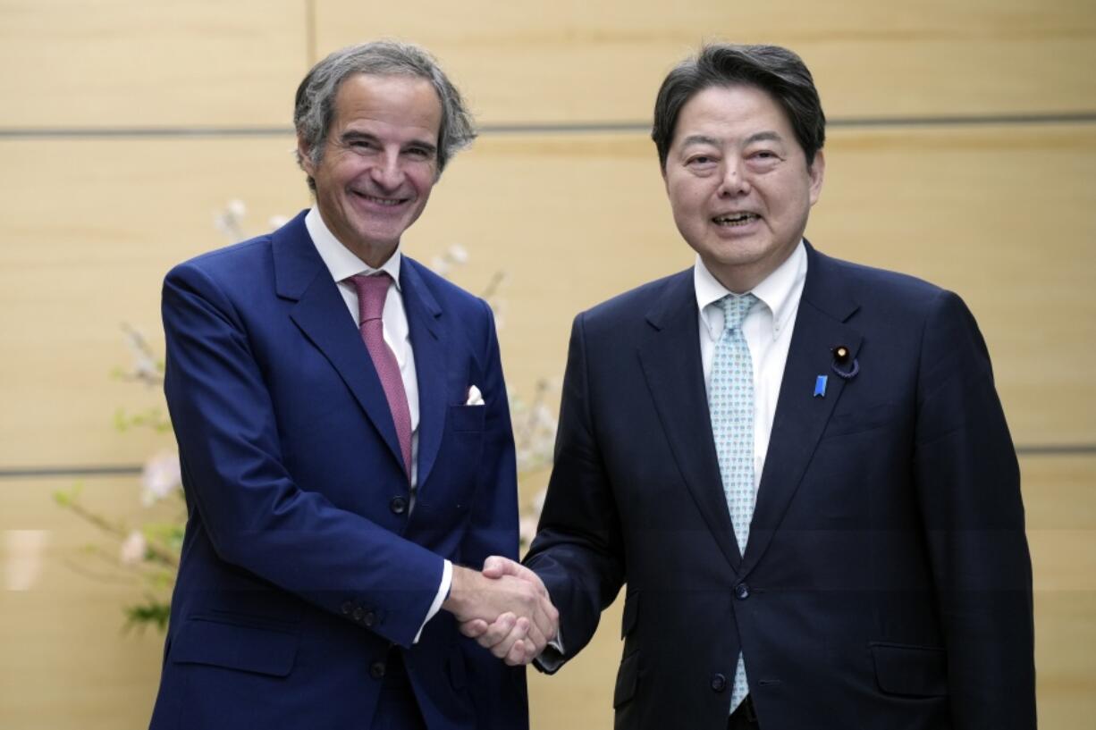 International Atomic Energy Agency Director General Rafael Mariano Grossi, left, and Japan&rsquo;s Chief Cabinet Secretary Yoshimasa Hayashi, right, shake hands during their meeting at the prime minister&rsquo;s office Tuesday, March 12, 2024, in Tokyo.