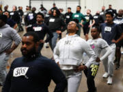 Philadelphia Police Academy applicants warm up before the physical fitness entry exam in Philadelphia, Saturday, Feb. 24, 2024. The city has moved to lower requirements for the entry physical exam at its police academy as part of a broader effort nationally to reevaluate policies that keep law enforcement applicants out of the job pool amid a hiring crisis.